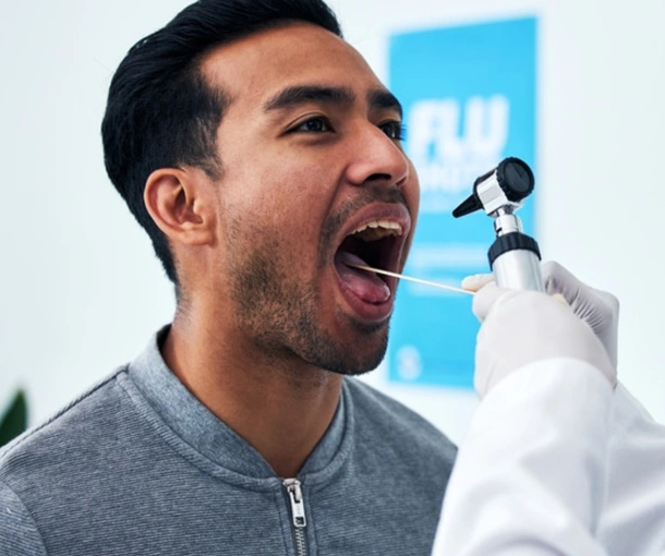 Man passionately speaking into microphone at professional dental event or presentation.